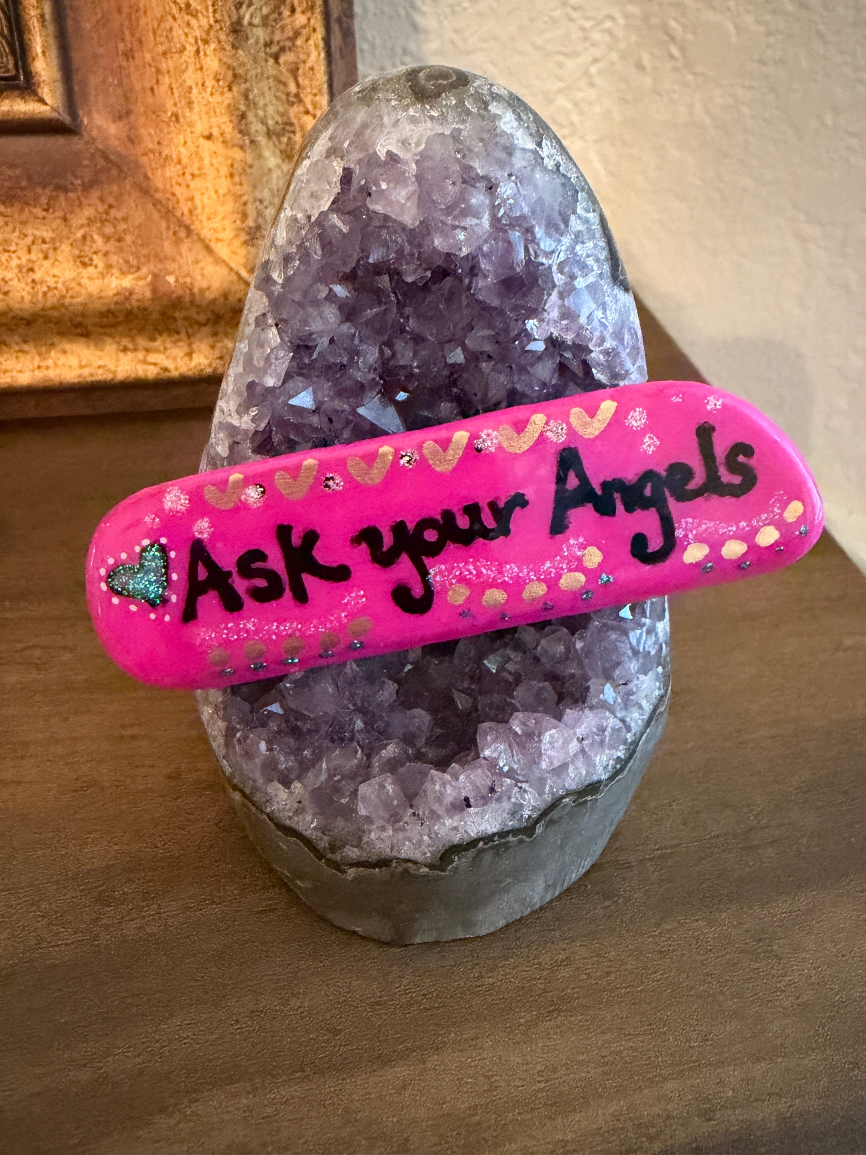 Pink hand-painted stone with 'Ask your Angels' text on an amethyst base