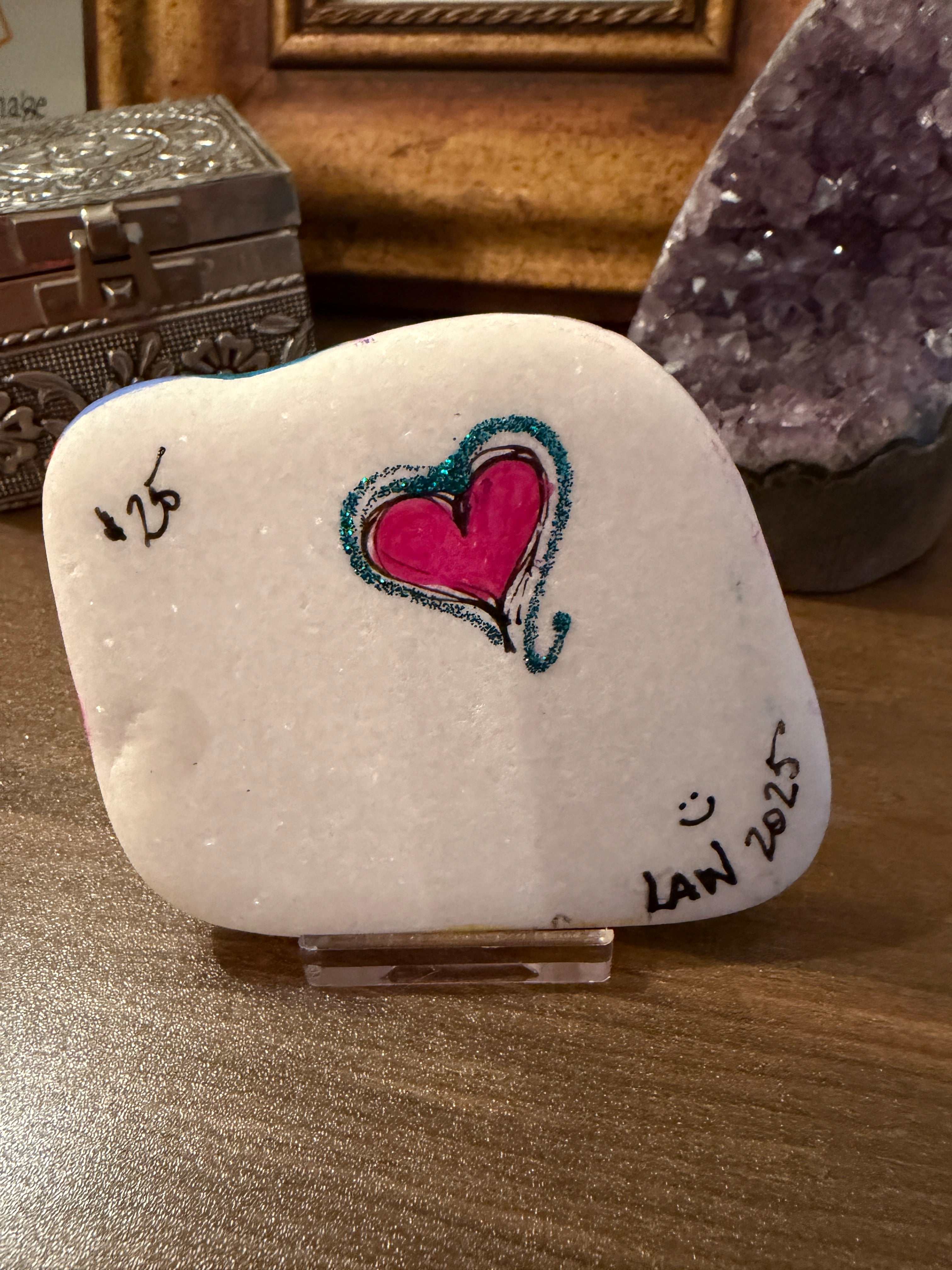Decorative stone with a heart design on a wooden surface